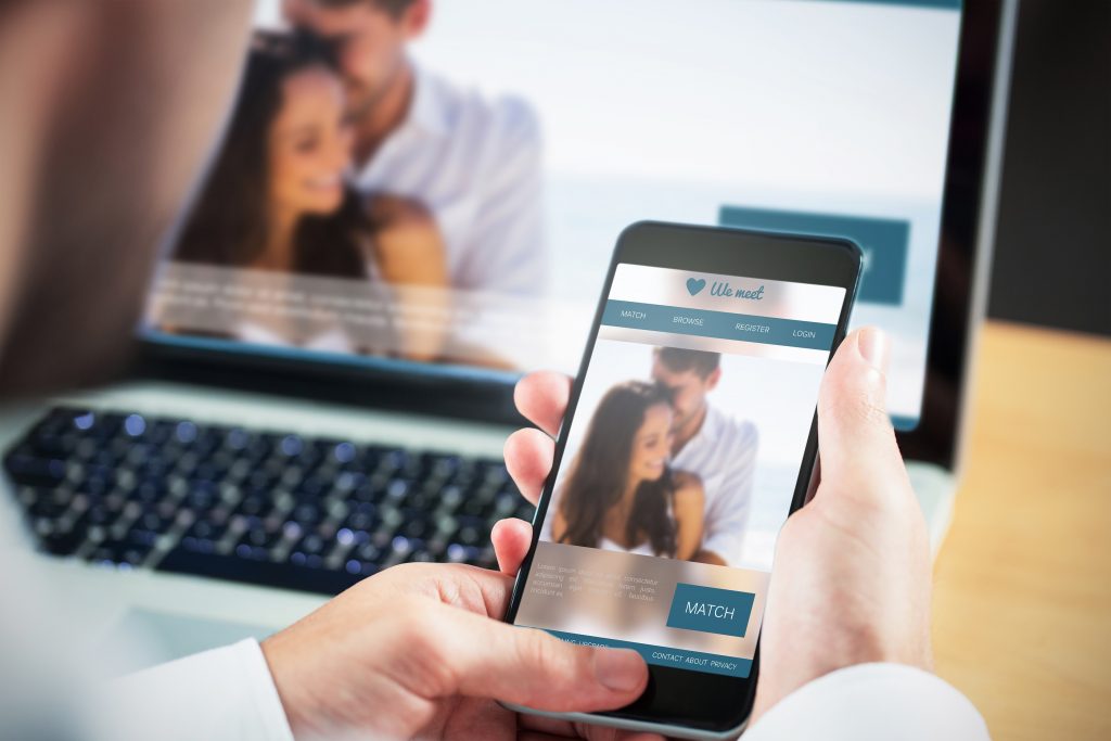 Businessman using smartphone against dating website