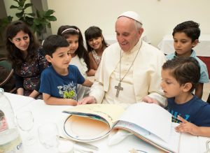 Pope Francis sits with refugee children from Syria at the Vatican Aug. 11. (CNS photo/L'Osservatore Romano via Reuters) See POPE-SYRIAN-REFUGEES Aug. 11, 2016. Editor's note: For editorial use only.