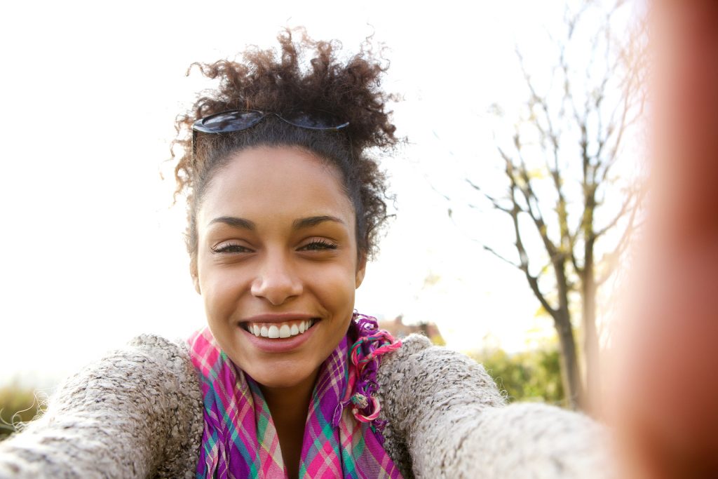 Young Woman Smiling And Talking A Selfie