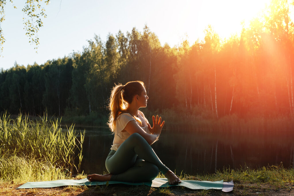 Young woman meditates in nature.