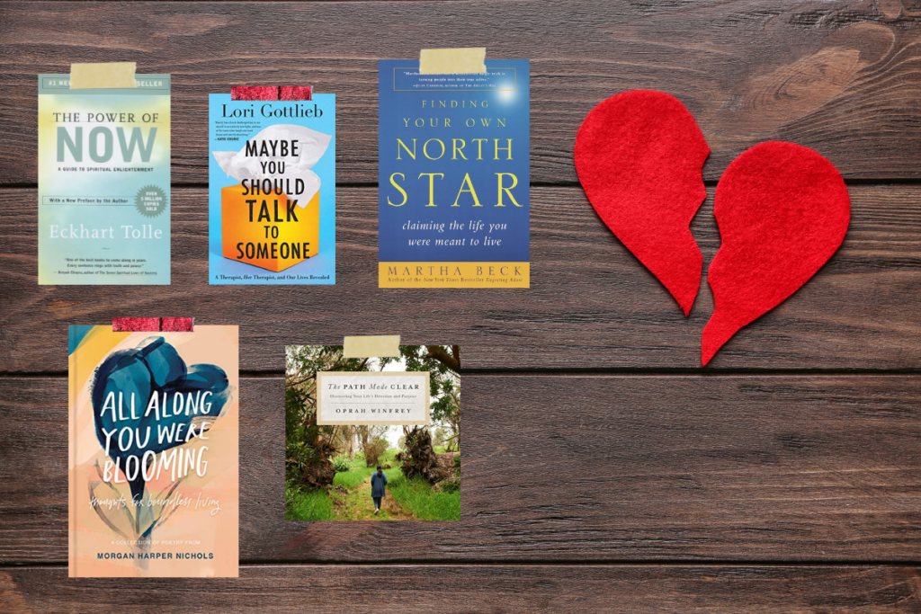 Five books on wood flooring next to felt broken heart