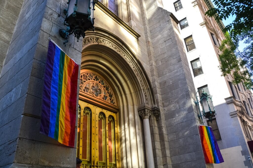 Outside of church with rainbow pride flags hanging