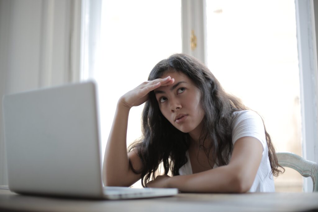 Young woman stressed out working at her computer