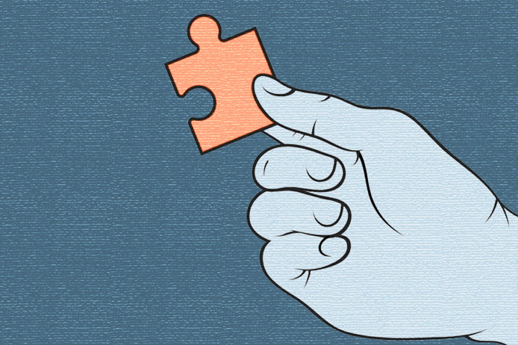 Blue hand holding an orange puzzle piece.