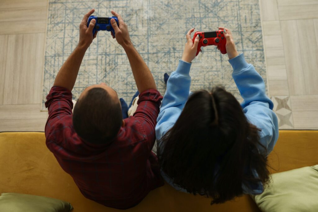 Man and woman playing video games overhead shot.